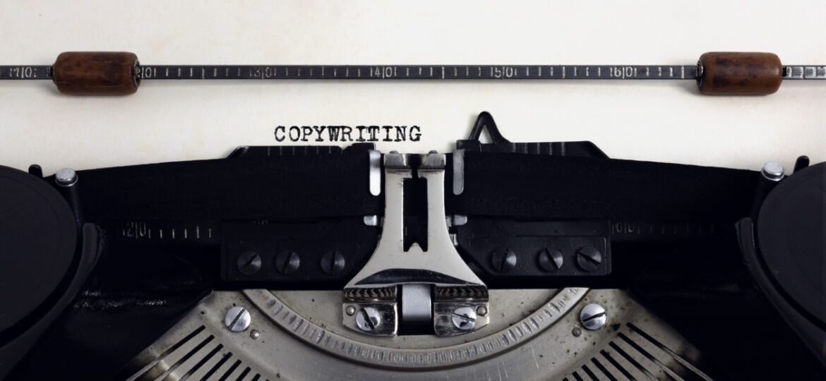 Old retro vintage black typewriter with close-up typing text Copywriting as heading on aged paper